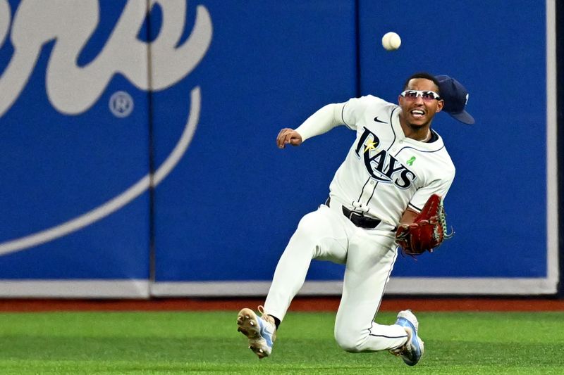 May 29, 2024; St. Petersburg, Florida, USA; Tampa Bay Rays right fielder Richie Palacios (1) slides to catch a line drive in the fifth inning against the Oakland Athletics  at Tropicana Field. Mandatory Credit: Jonathan Dyer-USA TODAY Sports