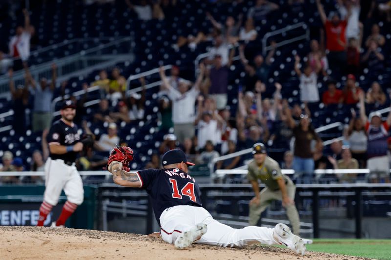 Jul 24, 2024; Washington, District of Columbia, USA; Washington Nationals relief pitcher Ildemaro Vargas (14) reacts after catching a line drive by San Diego Padres first baseman Jake Cronenworth (not pictured) during the ninth inning at Nationals Park. Mandatory Credit: Geoff Burke-USA TODAY Sports