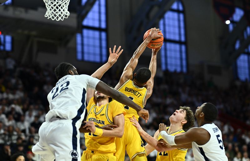 Jan 7, 2024; Philadelphia, Pennsylvania, USA; Michigan Wolverines guard Nimari Burnett (4) jumps for a rebound against the Penn State Nittany Lions in the first half at The Palestra. Mandatory Credit: Kyle Ross-USA TODAY Sports