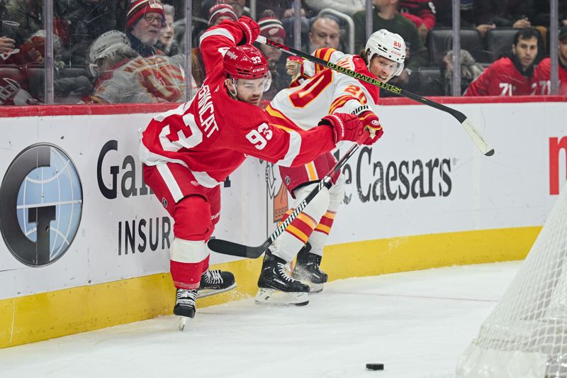 Nov 27, 2024; Detroit, Michigan, USA; Detroit Red Wings right wing Alex DeBrincat (93) and Calgary Flames center Blake Coleman (20) battle for the puck during the first period at Little Caesars Arena. Mandatory Credit: Tim Fuller-Imagn Images