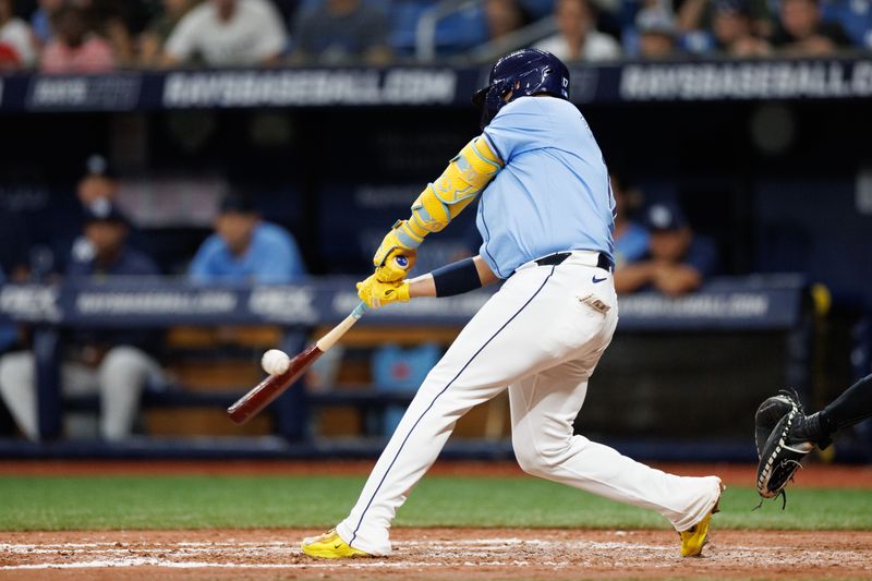 Jun 30, 2024; St. Petersburg, Florida, USA;  Tampa Bay Rays first baseman Isaac Paredes (17) doubles against the Washington Nationals in the sixth inning at Tropicana Field. Mandatory Credit: Nathan Ray Seebeck-USA TODAY Sports