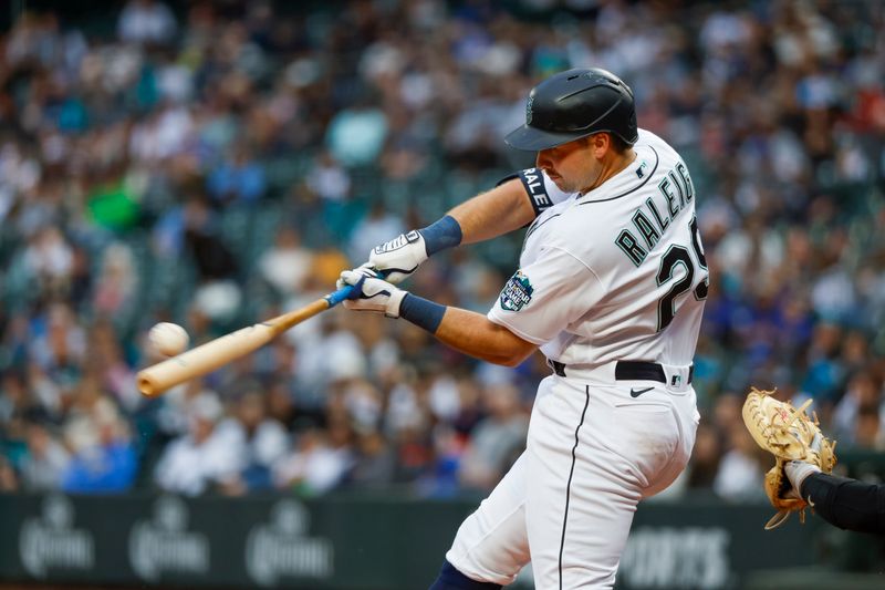 Jun 13, 2023; Seattle, Washington, USA; Seattle Mariners catcher Cal Raleigh (29) hits a three-run home run against the Miami Marlins during the second inning at T-Mobile Park. Mandatory Credit: Joe Nicholson-USA TODAY Sports