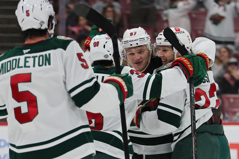 Oct 22, 2024; Sunrise, Florida, USA; Minnesota Wild center Marco Rossi (23) celebrates with teammates after scoring against the Florida Panthers during the first period at Amerant Bank Arena. Mandatory Credit: Sam Navarro-Imagn Images