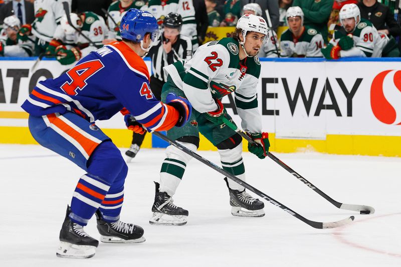 Nov 21, 2024; Edmonton, Alberta, CAN; Minnesota Wild forward Marat Khusnutdinov (22) tries to get a shot away in front of Edmonton Oilers defensemen Josh Brown (44) during the second period at Rogers Place. Mandatory Credit: Perry Nelson-Imagn Images