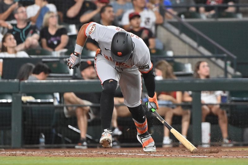 Jun 30, 2025; Phoenix, Arizona, USA;  San Francisco Giants outfielder Heliot Ramos (17) slams and breaks his bat on the ground after flying out in the seventh inning against the Arizona Diamondbacks at Chase Field. Mandatory Credit: Matt Kartozian-Imagn Images