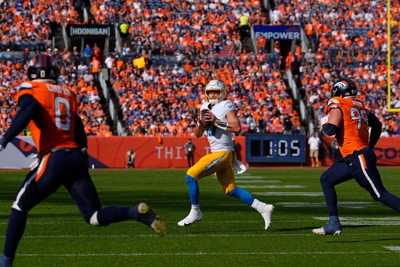 Los Angeles Chargers quarterback Justin Herbert (10) looks to pass during the first half of an NFL football game against the Denver Broncos, Sunday, Oct. 13, 2024, in Denver. (AP Photo/David Zalubowski)