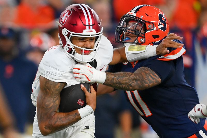 Sep 20, 2024; Syracuse, New York, USA; Syracuse Orange defensive lineman Denis Jaquez Jr. (11) sacks Stanford Cardinal quarterback Ashton Daniels (14) during the first half at the JMA Wireless Dome. Mandatory Credit: Rich Barnes-Imagn Images