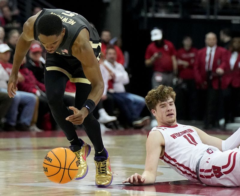 Mar. 2, 2023; Milwaukee, Wisconsin, USA; Purdue Boilermakers guard Brandon Newman (5) steals the ball from Wisconsin Badgers guard Max Klesmit (11) during the first half of their game at Kohl Center. Mandatory Credit: Mark Hoffman-USA TODAY Sports