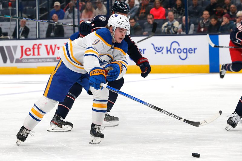 Oct 17, 2024; Columbus, Ohio, USA; Buffalo Sabres left wing  Zach Benson (9) reaches after a loose puck as Columbus Blue Jackets defenseman Jack Johnson (3) defends during the first period at Nationwide Arena. Mandatory Credit: Russell LaBounty-Imagn Images