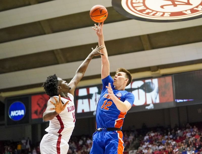 Feb 8, 2023; Tuscaloosa, Alabama, USA; Florida Gators forward Colin Castleton (12) shoots against Alabama Crimson Tide center Charles Bediako (14) during the first half at Coleman Coliseum. Mandatory Credit: Marvin Gentry-USA TODAY Sports