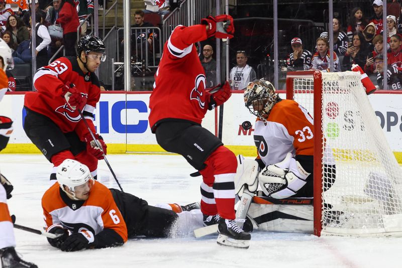 Dec 19, 2023; Newark, New Jersey, USA; Philadelphia Flyers goaltender Samuel Ersson (33) makes a save on New Jersey Devils center Nico Hischier (13) during the second period at Prudential Center. Mandatory Credit: Ed Mulholland-USA TODAY Sports