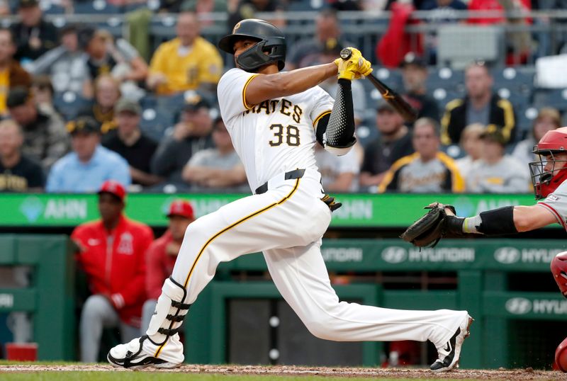 May 6, 2024; Pittsburgh, Pennsylvania, USA;  Pittsburgh Pirates right fielder Edward Olivares (38) hits a grand slam home run against the Los Angeles Angels during the third inning at PNC Park. Mandatory Credit: Charles LeClaire-USA TODAY Sports