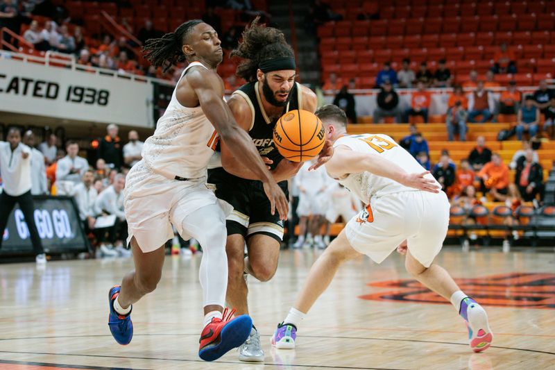 Dec 20, 2023; Stillwater, Oklahoma, USA; Wofford Terriers guard Corey Tripp (10) tries to drive through Oklahoma State Cowboys guard Javon Small (12) and Oklahoma State Cowboys guard Connor Dow (13) during the second half at Gallagher-Iba Arena. Mandatory Credit: William Purnell-USA TODAY Sports