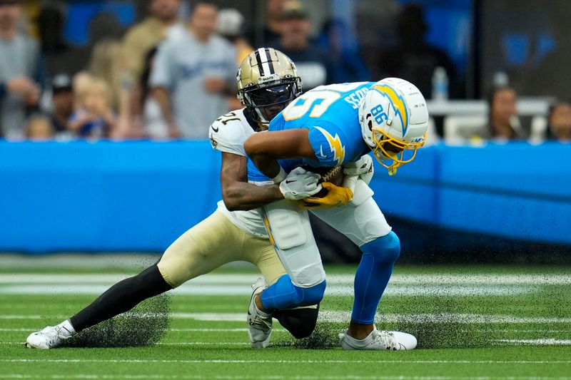 Los Angeles Chargers wide receiver Keelan Doss (86) is tackled by New Orleans Saints cornerback Bradley Roby in the first half of an NFL football game in Inglewood, Calif., Sunday, Aug. 20, 2023. (AP Photo/Marcio Jose Sanchez)