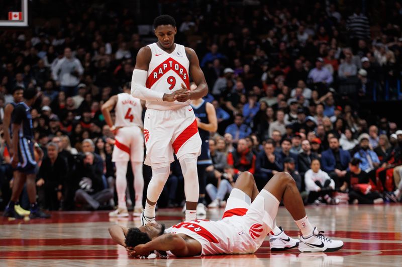 TORONTO, CANADA - JANUARY 22: RJ Barrett #9 of the Toronto Raptors walks over to Thaddeus Young #21 on the floor during the second half against the Memphis Grizzlies at Scotiabank Arena on January 22, 2024 in Toronto, Canada. NOTE TO USER: User expressly acknowledges and agrees that, by downloading and or using this photograph, User is consenting to the terms and conditions of the Getty Images License Agreement. (Photo by Cole Burston/Getty Images)