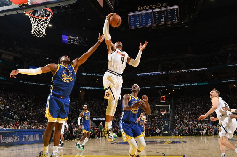 SAN FRANCISCO, CA - MARCH 17: Moses Moody #4 of the Golden State Warriors rebounds the ball during the game against the Golden State Warriors on March 17, 2025 at Chase Center in San Francisco, California. NOTE TO USER: User expressly acknowledges and agrees that, by downloading and or using this photograph, user is consenting to the terms and conditions of Getty Images License Agreement. Mandatory Copyright Notice: Copyright 2025 NBAE (Photo by Noah Graham/NBAE via Getty Images)