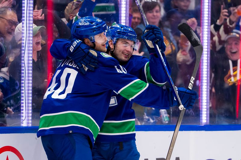 Apr 16, 2024; Vancouver, British Columbia, CAN;  Vancouver Canucks forward Elias Pettersson (40) and forward Nils Hoglander (21) celebrate Hoglander’s goal against the Calgary Flames in the first period at Rogers Arena. Mandatory Credit: Bob Frid-USA TODAY Sports