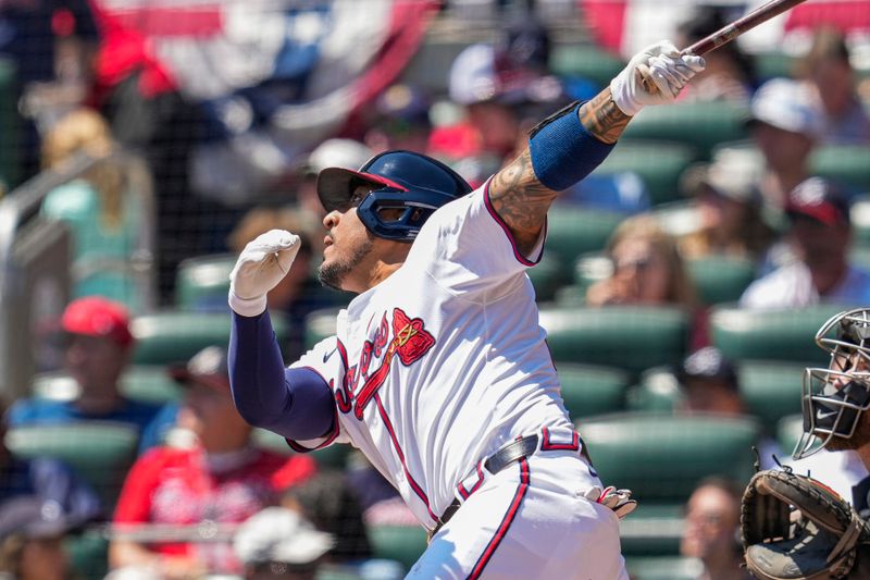 Apr 7, 2024; Cumberland, Georgia, USA; Atlanta Braves catcher Chadwick Tromp (45) hits a run scoring sacrifice fly ball against the Arizona Diamondbacks during the second inning at Truist Park. Mandatory Credit: Dale Zanine-USA TODAY Sports