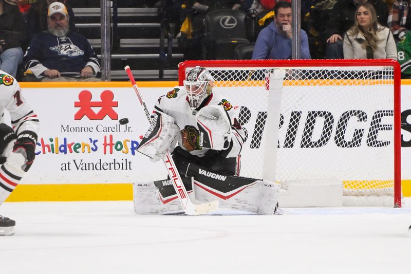 Jan 16, 2025; Nashville, Tennessee, USA;  Chicago Blackhawks goaltender Arvid Soderblom (40) makes a glove save against the Nashville Predators during the overtime period at Bridgestone Arena. Mandatory Credit: Steve Roberts-Imagn Images