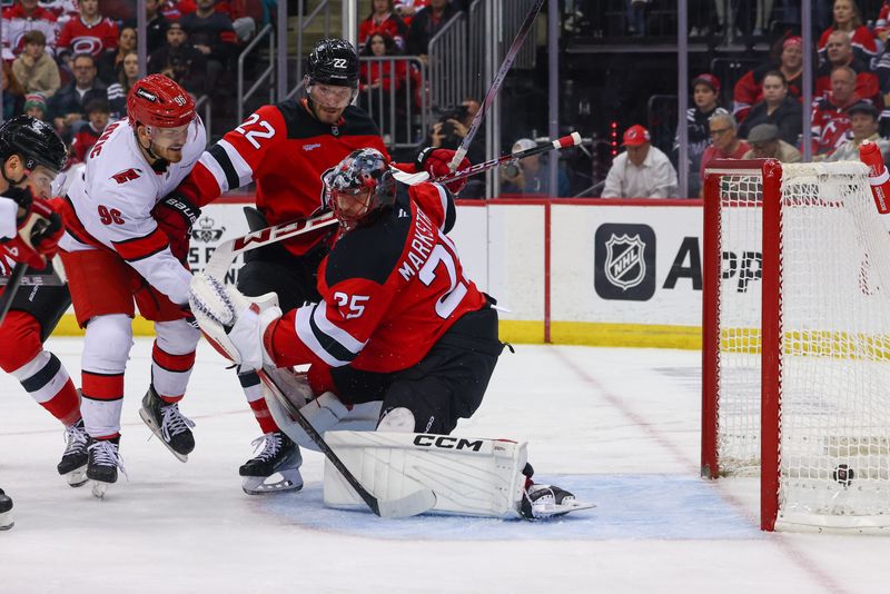 Nov 21, 2024; Newark, New Jersey, USA; Carolina Hurricanes center Jack Roslovic (96) scores a goal on New Jersey Devils goaltender Jacob Markstrom (25) during the first period at Prudential Center. Mandatory Credit: Ed Mulholland-Imagn Images