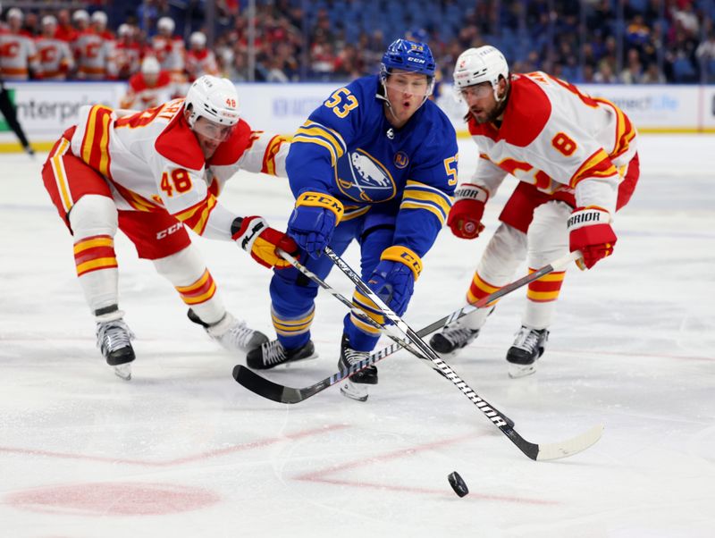 Oct 19, 2023; Buffalo, New York, USA;  Buffalo Sabres left wing Jeff Skinner (53) skates for a loose puck as Calgary Flames defenseman Dennis Gilbert (48) and defenseman Chris Tanev (8) try to defend during the second period at KeyBank Center. Mandatory Credit: Timothy T. Ludwig-USA TODAY Sports