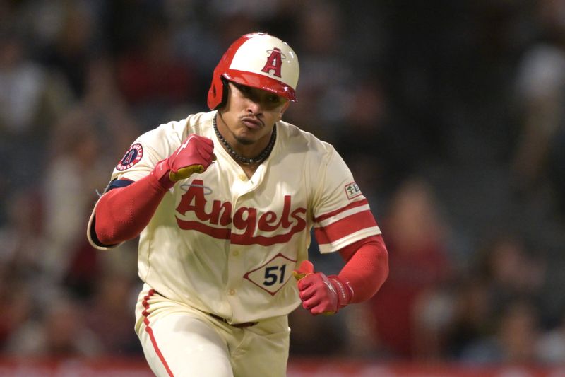 Sep 16, 2024; Anaheim, California, USA;  Los Angeles Angels right fielder Gustavo Campero (51) pumps his fist as he runs to first on a RBI single in the seventh inning  against the Chicago White Sox at Angel Stadium. Mandatory Credit: Jayne Kamin-Oncea-Imagn Images