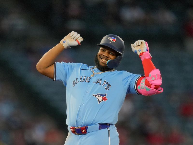 Aug 14, 2024; Anaheim, California, USA; Toronto Blue Jays first baseman Vladimir Guerrero Jr. (27) celebrates after hitting a double in the fifth inning against the Los Angeles Angels at Angel Stadium. Mandatory Credit: Kirby Lee-USA TODAY Sports