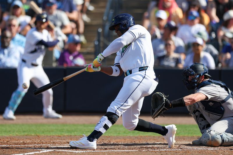 Apr 19, 2025; Tampa, Florida, USA;  Tampa Bay Rays designated hitter Yandy Diaz (2) hits a base hit against the New York Yankees in the third inning at George M. Steinbrenner Field. Mandatory Credit: Nathan Ray Seebeck-Imagn Images