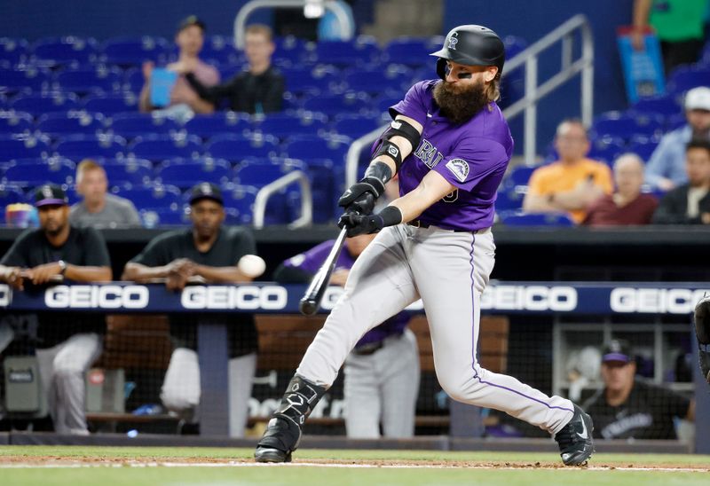 Apr 30, 2024; Miami, Florida, USA;  Colorado Rockies outfielder Charlie Blackmon (19) singles in a run against the Miami Marlins in the first inning at loanDepot Park. Mandatory Credit: Rhona Wise-USA TODAY Sports