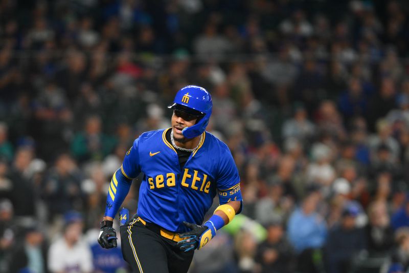 Sep 14, 2024; Seattle, Washington, USA; Seattle Mariners center fielder Julio Rodriguez (44) runs toward first base after hitting a single against the Texas Rangers during the first inning at T-Mobile Park. Mandatory Credit: Steven Bisig-Imagn Images