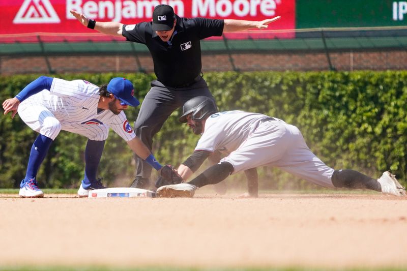 May 7, 2023; Chicago, Illinois, USA; Miami Marlins shortstop Jon Berti (5) steals second base as Chicago Cubs shortstop Dansby Swanson (7) takes the throw during the eighth inning at Wrigley Field. Mandatory Credit: David Banks-USA TODAY Sports