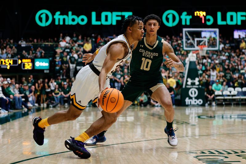 Mar 2, 2024; Fort Collins, Colorado, USA; Wyoming Cowboys guard Sam Griffin (3) controls the ball as Colorado State Rams guard Nique Clifford (10) guards in the second half at Moby Arena. Mandatory Credit: Isaiah J. Downing-USA TODAY Sports