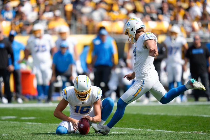 Los Angeles Chargers place-kicker Cameron Dicker, right, boots a field goal during the first half of an NFL football game against the Pittsburgh Steelers, Sunday, Sept. 22, 2024, in Pittsburgh. (AP Photo/Gene J. Puskar)