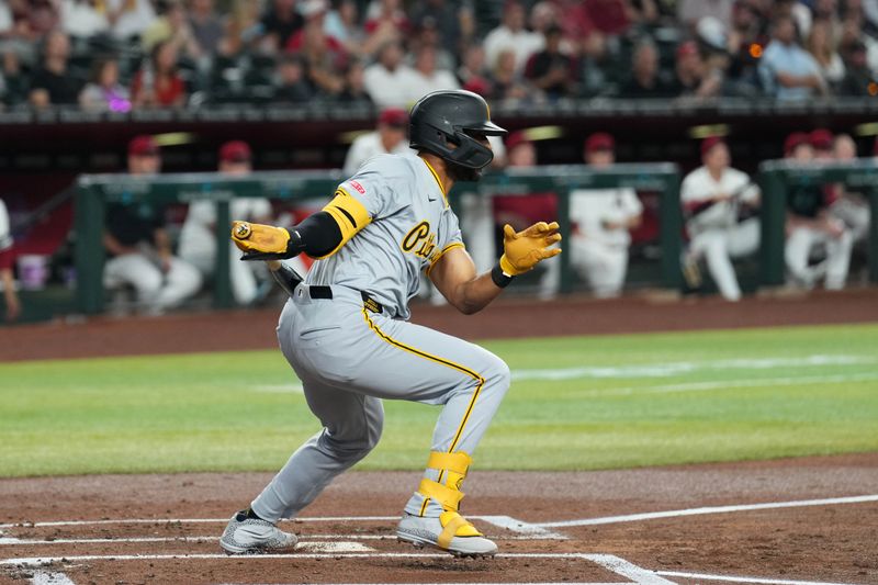 Jul 26, 2024; Phoenix, Arizona, USA; Pittsburgh Pirates outfielder Joshua Palacios (77) hits a two RBI single against the Arizona Diamondbacks during the first inning at Chase Field. Mandatory Credit: Joe Camporeale-USA TODAY Sports