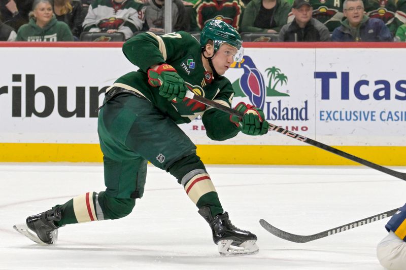 Jan 25, 2024; Saint Paul, Minnesota, USA; Minnesota Wild forward Kirill Kaprizov (97) assists on a power play goal of forward Joel Eriksson Ek (14) against the Nashville Predators during the second period at Xcel Energy Center. Mandatory Credit: Nick Wosika-USA TODAY Sports