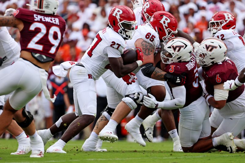 Sep 21, 2024; Blacksburg, Virginia, USA; Rutgers Scarlet Knights running back Samuel Brown V (27) runs the ball during the first quarter against the Virginia Tech Hokies at Lane Stadium. Mandatory Credit: Peter Casey-Imagn Images