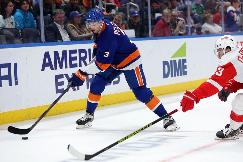 Oct 22, 2024; Elmont, New York, USA; New York Islanders defenseman Adam Pelech (3) skates with the puck against Detroit Red Wings right wing Alex DeBrincat (93) during the third period at UBS Arena. Mandatory Credit: Brad Penner-Imagn Images