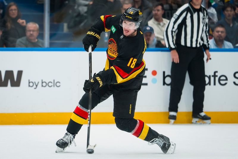 Nov 20, 2025; Vancouver, British Columbia, CAN; Vancouver Canucks forward Drew O'Connor (18) shoots against the Dallas Stars in the second period at Rogers Arena. Mandatory Credit: Bob Frid-Imagn Images