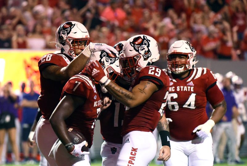 Sep 18, 2021; Raleigh, North Carolina, USA; North Carolina State Wolfpack running back Zonovan Knight (7) is greeted by tight end Christopher Toudle (29) during the first half at Carter-Finley Stadium. Mandatory Credit: Rob Kinnan-USA TODAY Sports