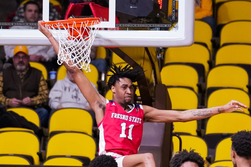 Jan 31, 2023; Laramie, Wyoming, USA; Fresno State Bulldogs forward Isaih Moore (11) finishes a dunk against the Wyoming Cowboys during the first half at Arena-Auditorium. Mandatory Credit: Troy Babbitt-USA TODAY Sports