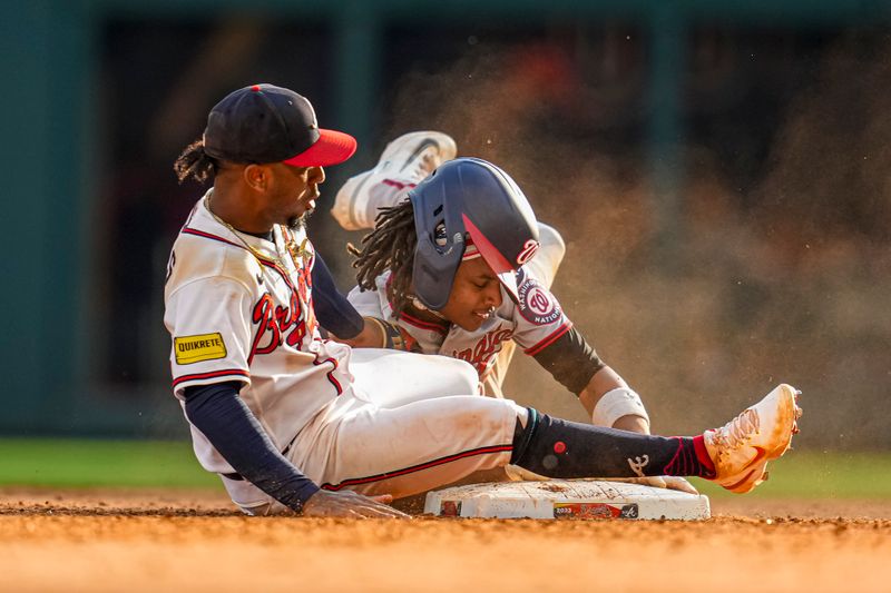 Oct 1, 2023; Cumberland, Georgia, USA; Washington Nationals shortstop CJ Abrams (5) collides with Atlanta Braves second baseman Ozzie Albies (1) after stealing second base during the eighth inning at Truist Park. Mandatory Credit: Dale Zanine-USA TODAY Sports