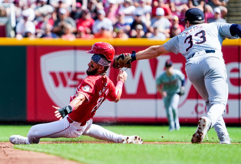 Jul 6, 2024; CINCINNATI, OHIO: Cincinnati Reds outfielder Nick Martini (23) is tagged out  by Detroit Tigers second base Colt Keith (33) in the 2nd inning at Great American Ball Park Saturday July 6, 2024. Mandatory Credit: Cara Owsley-The Enquirer