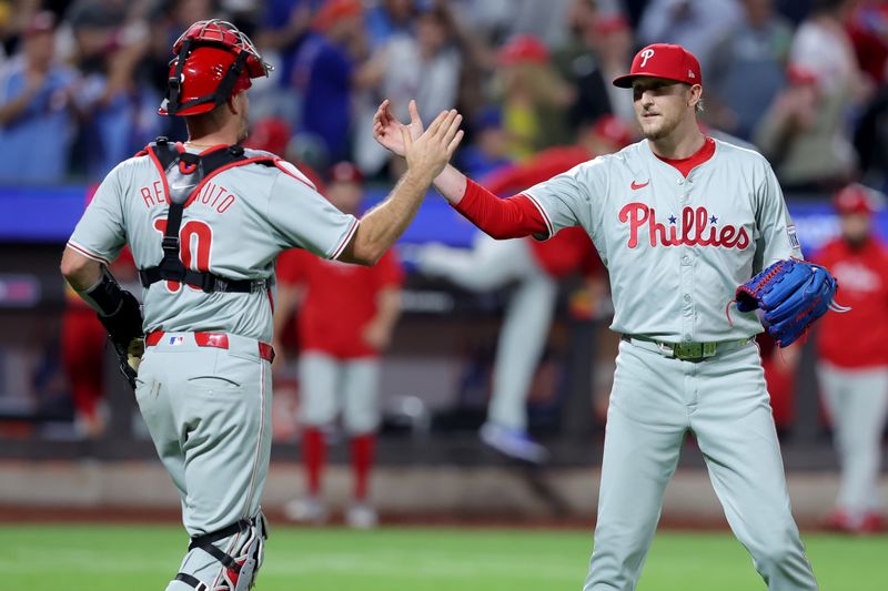 Sep 20, 2024; New York City, New York, USA; Philadelphia Phillies relief pitcher Jeff Hoffman (23) and catcher J.T. Realmuto (10) celebrate after defeating the New York Mets at Citi Field. Mandatory Credit: Brad Penner-Imagn Images