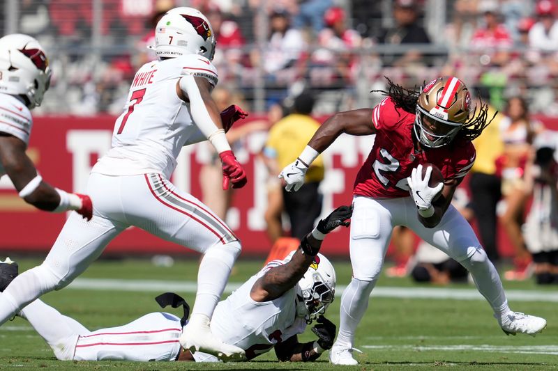 San Francisco 49ers running back Jordan Mason, right, runs against the Arizona Cardinals during the first half of an NFL football game in Santa Clara, Calif., Sunday, Oct. 6, 2024. (AP Photo/Godofredo A. Vásquez)