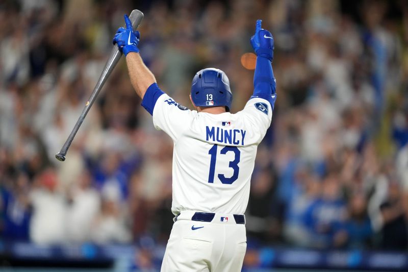 May 20, 2025; Los Angeles, California, USA; Los Angeles Dodgers third baseman Max Muncy (13) celebrates after hitting a sacrifice fly in the 10th inning against the Arizona Diamondbacks at Dodger Stadium. Mandatory Credit: Kirby Lee-Imagn Images