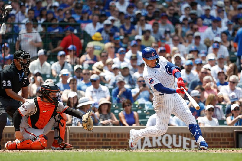 Jun 19, 2024; Chicago, Illinois, USA; Chicago Cubs catcher Miguel Amaya (9) singles against the San Francisco Giants during the fourth inning at Wrigley Field. Mandatory Credit: Kamil Krzaczynski-USA TODAY Sports