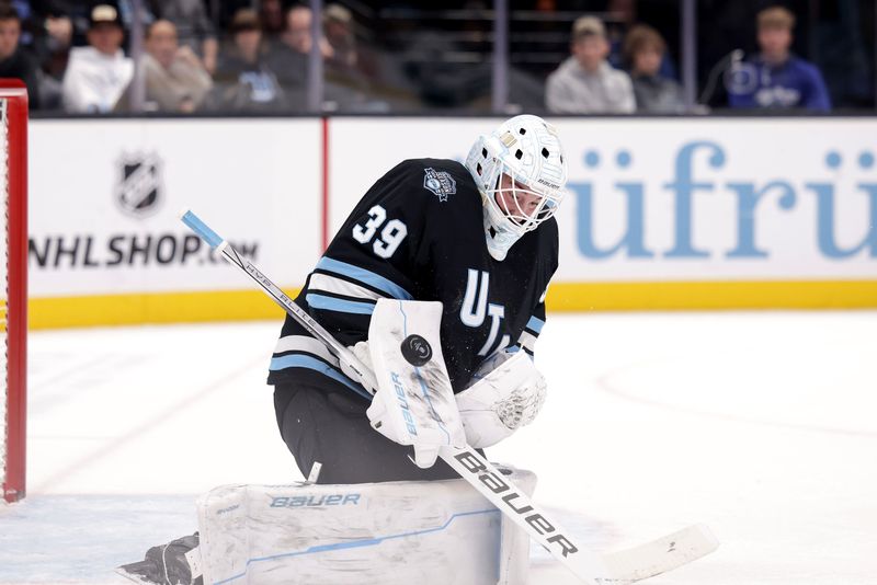 Oct 28, 2024; Salt Lake City, Utah, USA;  Utah Hockey Club goaltender Connor Ingram (39) blocks a shot during the third period against the San Jose Sharks at Delta Center. Mandatory Credit: Chris Nicoll-Imagn Images