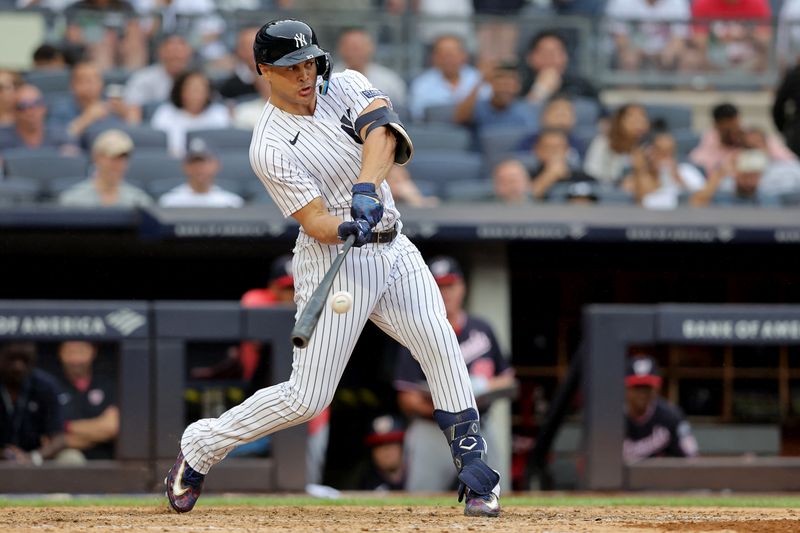 Aug 24, 2023; Bronx, New York, USA; New York Yankees designated hitter Giancarlo Stanton (27) hits a solo home run against the Washington Nationals during the eighth inning at Yankee Stadium. Mandatory Credit: Brad Penner-USA TODAY Sports