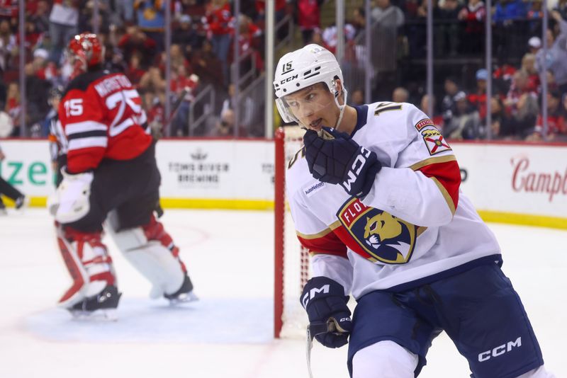 Jan 14, 2025; Newark, New Jersey, USA; Florida Panthers center Anton Lundell (15) celebrates his game winning goal on New Jersey Devils goaltender Jacob Markstrom (25) during the overtime shootout at Prudential Center. Mandatory Credit: Ed Mulholland-Imagn Images