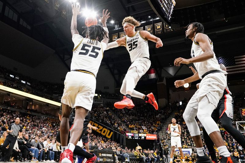 Jan 6, 2024; Columbia, Missouri, USA; Georgia Bulldogs guard Justin Hill (11) shoots as Missouri Tigers forward Noah Carter (35) and guard Sean East II (55) defend during the firsthalf at Mizzou Arena. Mandatory Credit: Denny Medley-USA TODAY Sports